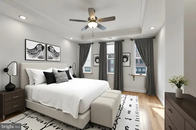 a bedroom with a large bed and a chandelier