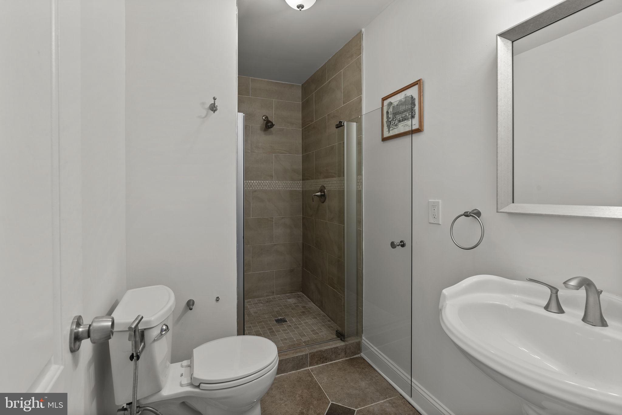 722 Lennox Street Baltimore, MD 21217 - Photo 35 of 52 a bathroom with a sink toilet and shower