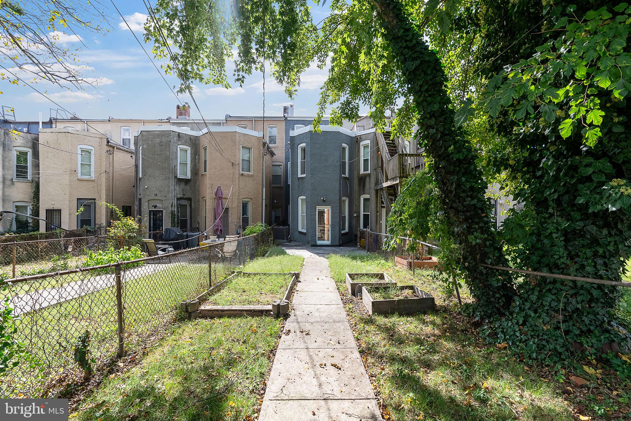 722 Lennox Street Baltimore, MD 21217 - Photo 40 of 52 a view of swimming pool with outdoor seating and a garden