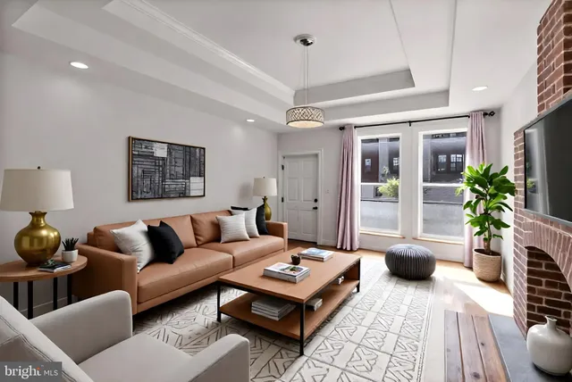 a living room with furniture and a potted plant