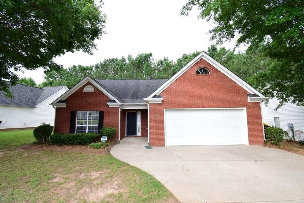 153 Riva Ridge Lane Newnan, GA 30263 - Photo 1 of 1 a front view of a house with a yard and garage