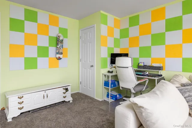 a room with a workspace and a chair