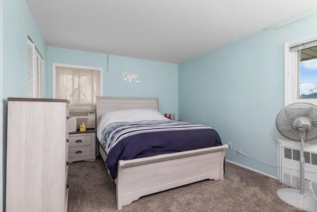 a bedroom with a bed and chandelier
