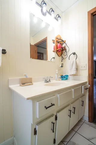 a living room with furniture a flat screen tv and a wooden floor