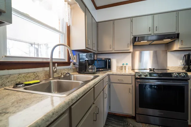 a view of a house with backyard and sitting area