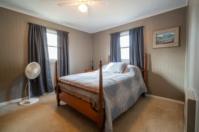 a bed sitting in a bedroom next to a window