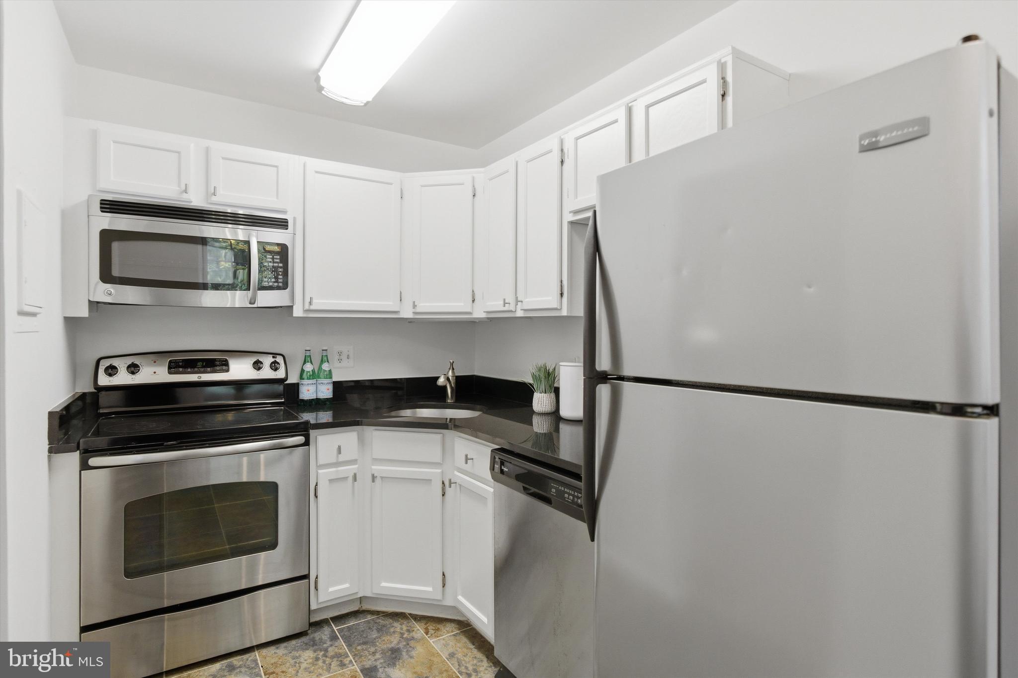 1909 North Rhodes Street, Unit 25 Arlington, VA 22201 - Photo 5 of 16 a white refrigerator freezer and a stove top oven