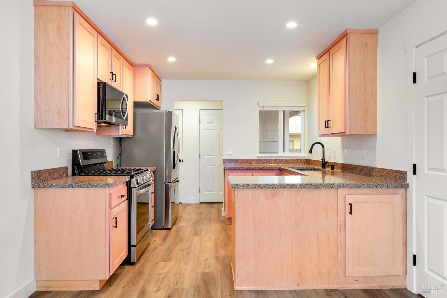 1536 Marlow Road Santa Rosa, CA 95401 - Photo 7 of 21 a kitchen with stainless steel appliances granite countertop a sink stove and refrigerator