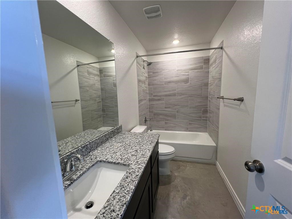 1274 Lehmann Drive, Unit A Copperas Cove, TX 76522 - Photo 6 of 8 a bathroom with a granite countertop sink a toilet and shower