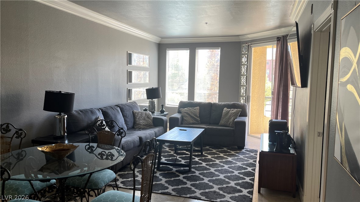 210 East Flamingo Road, Unit 205 Las Vegas, NV 89169 - Photo 4 of 17 A gracefully appointed living space offers a smooth flow from dining to lounging, crowned with elegant crown molding.