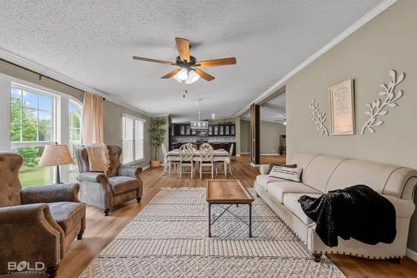 a living room with furniture and a chandelier