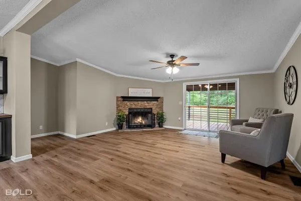a bedroom with a bed ceiling fan and a window