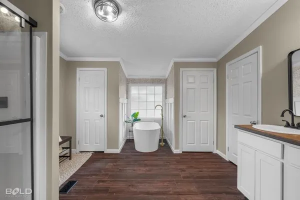 a bed sitting in a bedroom next to a window