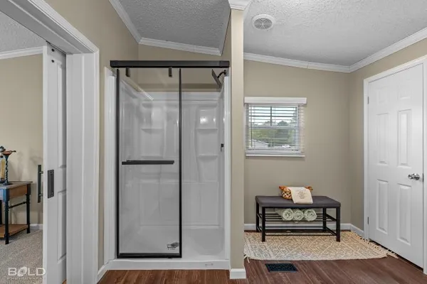 an empty room with a chandelier fan and windows