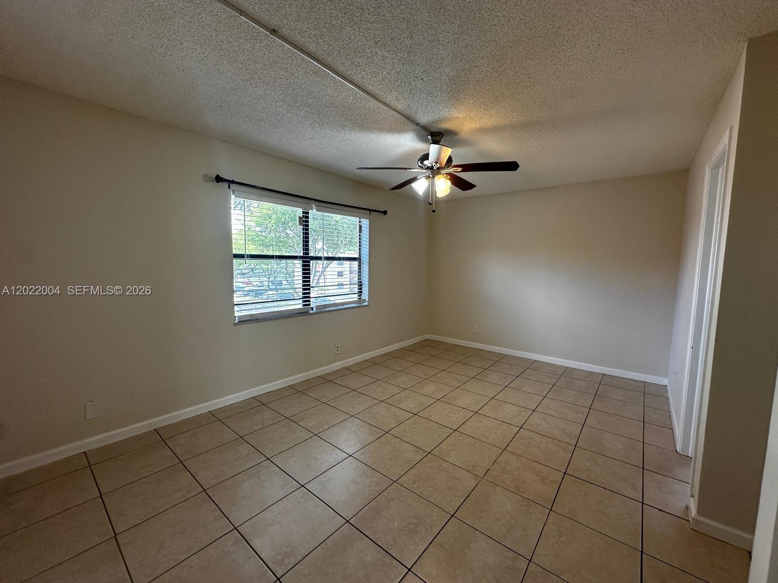 3400 Foxcroft Road, Unit 301 Miramar, FL 33025 - Photo 40 of 72 an empty room with windows and fan