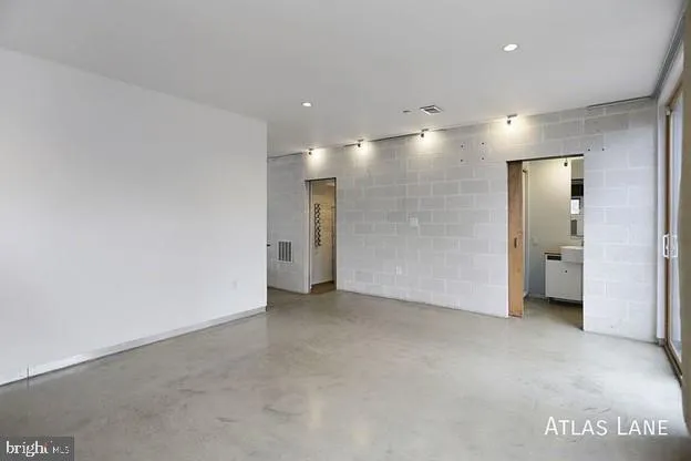 a white toilet sitting next to a bathroom sink