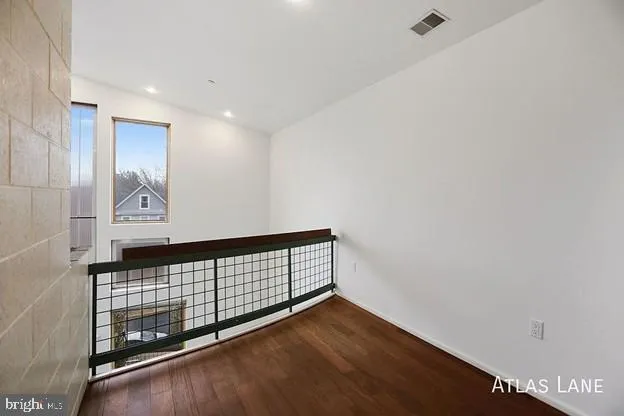 a view of a room with wooden floor