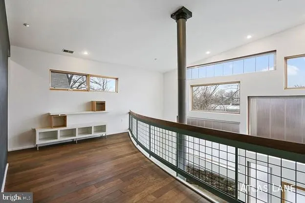 a view of a hallway with furniture and windows