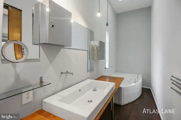 a bathroom with a sink a mirror and shower
