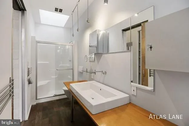 a view of a white house with a large tree