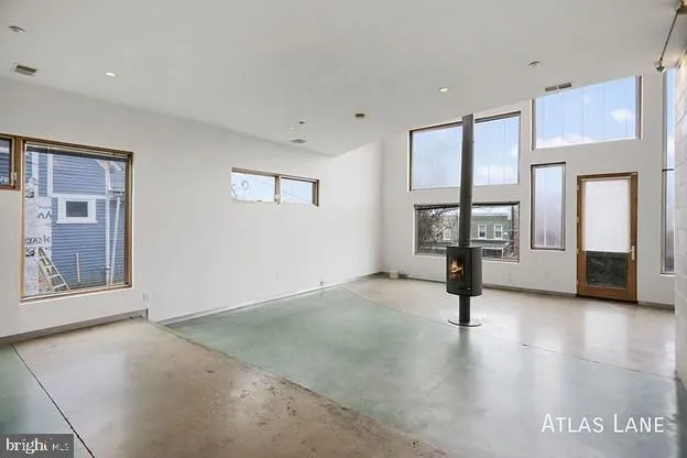 a large kitchen with a large counter top stainless steel appliances and cabinets
