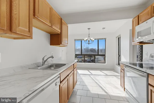 a kitchen with stainless steel appliances granite countertop a sink and a stove