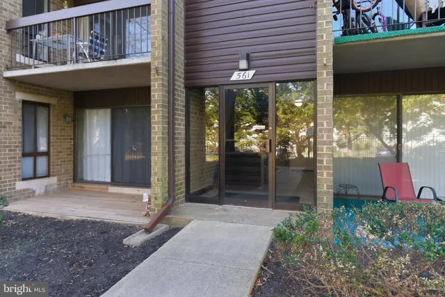 a view of a porch with a floor to ceiling window and wooden fence