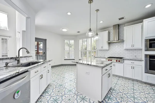 a kitchen with a sink stove and cabinets