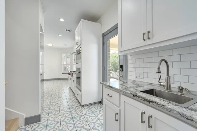 a kitchen with a sink and a refrigerator