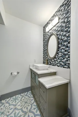a bathroom with a sink mirror vanity and toilet
