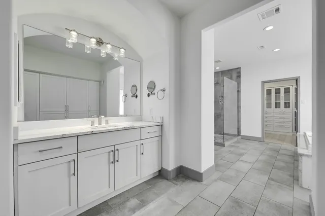 a bathroom with a double vanity sink and a mirror