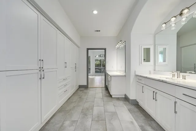 a bathroom with a double vanity sink a mirror and a shower