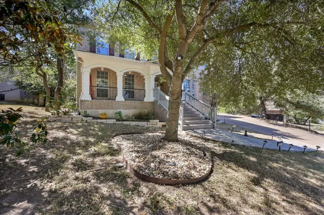 a view of a white house with a yard