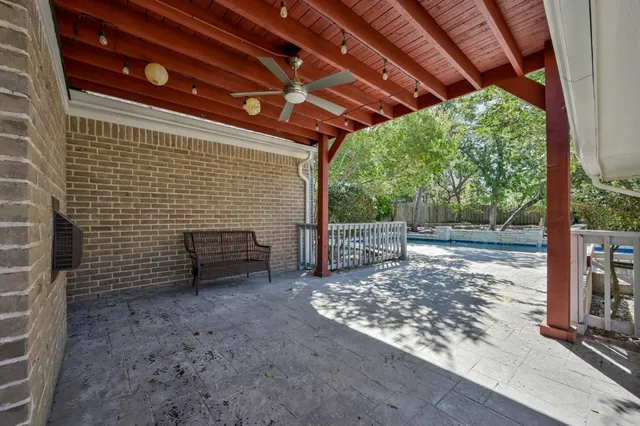 a view of a backyard with wooden fence and floor