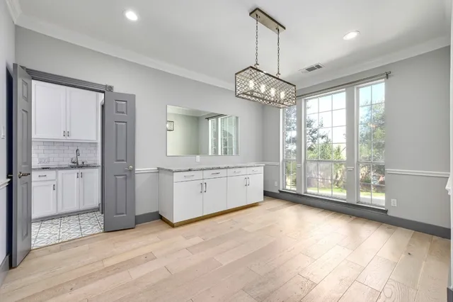 a view of a kitchen with a stove and wooden floor