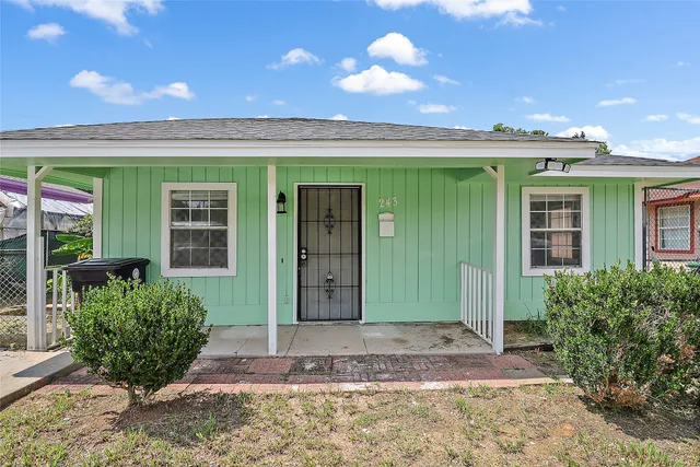 a view of a house with potted plants