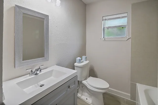 a bathroom with a sink toilet and a mirror