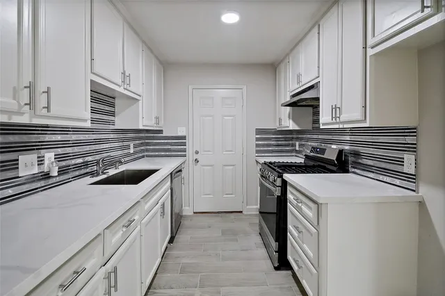 a kitchen with stainless steel appliances a stove and a refrigerator