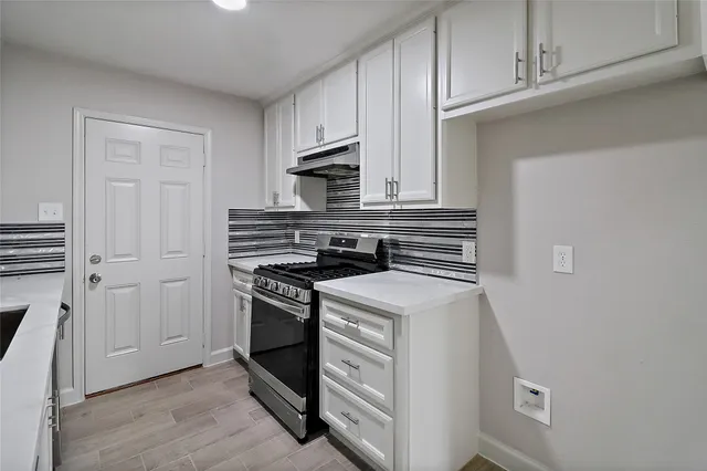 a kitchen with a stove and a microwave