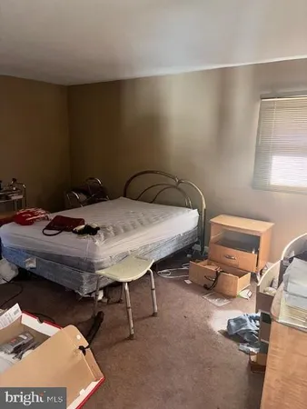 a bed sitting in a bedroom next to a window