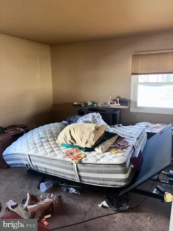 a bed sitting in a bedroom next to a window