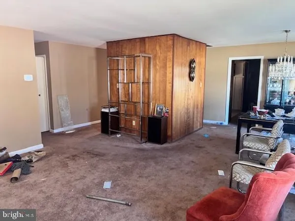 a living room with furniture gym equipment and a window