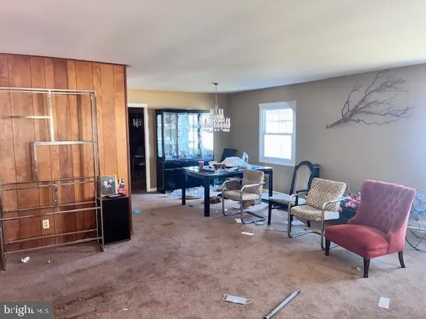 a living room with furniture windows and a flat screen tv