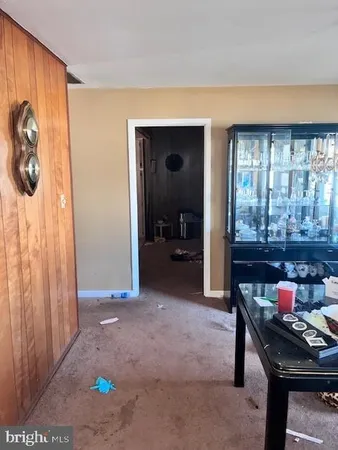 a dining room with furniture and a window
