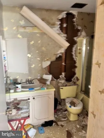 a bathroom with a sink a toilet and a mirror