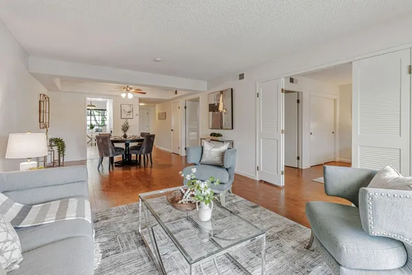 a living room with furniture and a dining table