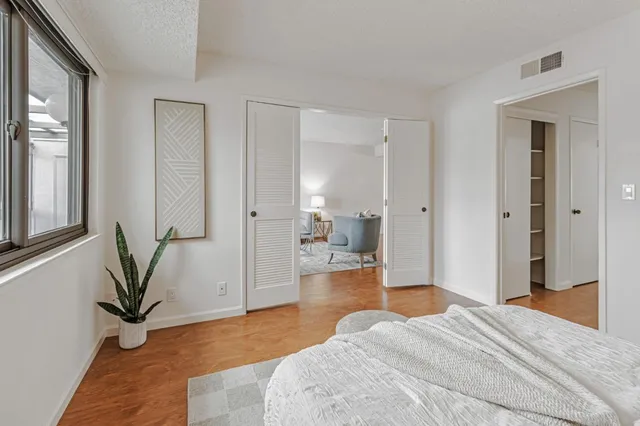 a bedroom with a bed and a large mirror