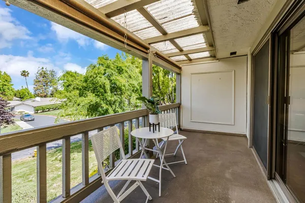 a view of a chairs and table in the balcony