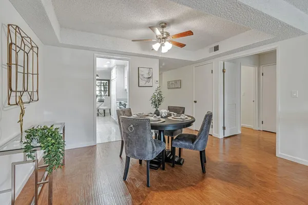 a view of a dining room with furniture and wooden floor