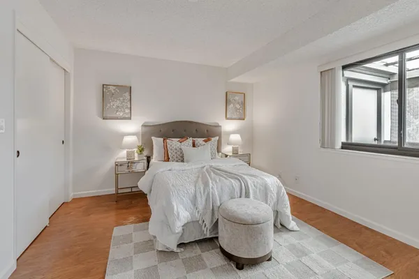 a bedroom with a bed and a window